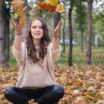 beautiful girl, in the park, throwing leaves