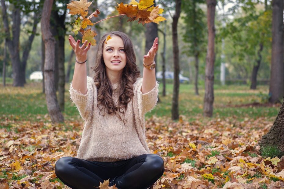 beautiful girl, in the park, throwing leaves